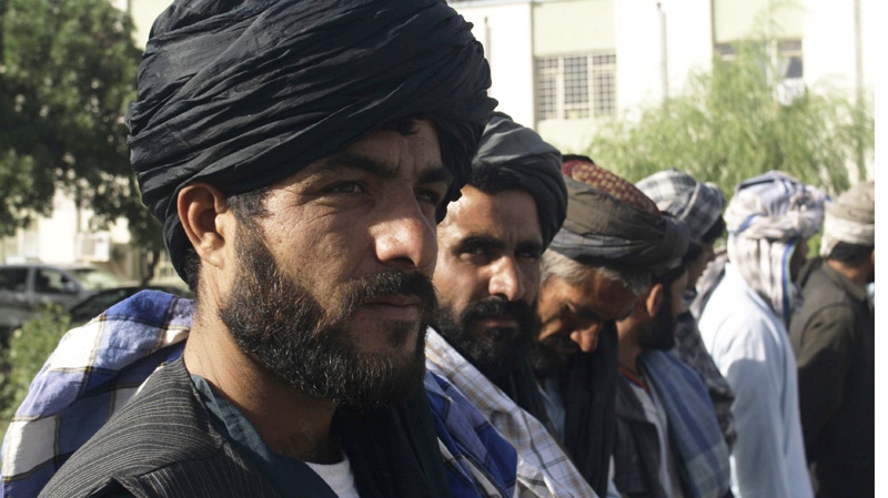Former Taliban militants stand during a joining ceremony with the Afghan government in support of the Peace Jirga which was held a couple of days ago, in Herat, west of Kabul, Afghanistan, Sunday, June 13, 2010. (AP / Reza Shirmohammadi)