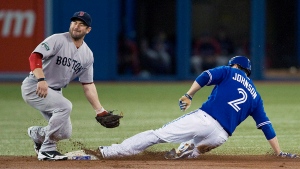 Toronto Blue Jays Kelly Johnson slides safely under the tag of Boston Red Sox second baseman Nick Punto as he steals second base during first inning MLB action in Toronto on Sunday, June 3, 2012. THE CANADIAN PRESS/Aaron Vincent Elkaim

