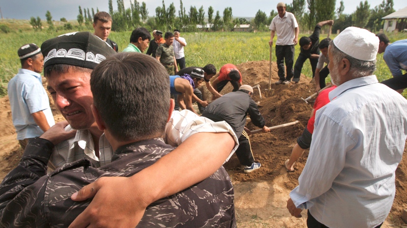 Uzbek men mourn during funeral ceremony of a victim who died after ethnic rioting between Kyrgyz and ethnic Uzbeks, in the southern Kyrgyz city of Osh, Tuesday, June 15, 2010. (AP / Sergei Grits)