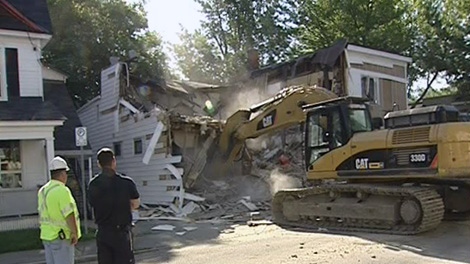 Residents celebrated as crews tore down this vacant home in Hintonburg that had become a problem for the community, Tuesday, June 15, 2010.