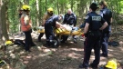 Rescue workers help a man who was trapped on a rocky cliff in Mount Nemo Conservation Area, Wednesday, May 16, 2012. (Tom Podolec / CTV News)
