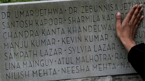 Renee Saklikar runs her hand across the names of victims on a memorial honouring those killed in the bombing of Air India Flight 182, at Stanley Park in Vancouver, B.C., on Thursday June 17, 2010. Her aunt and uncle, doctors Zebunnisa Jethwa and Umar Jethwa were killed in the bombing. (THE CANADIAN PRESS/Darryl Dyck)