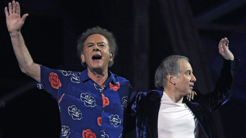 Paul Simon, right, and Art Garfunkel arrive on stage at the 25th Anniversary Rock & Roll Hall of Fame concert at Madison Square Garden,Thursday, Oct. 29, 2009 in New York. (AP Photo/Henny Ray Abrams)