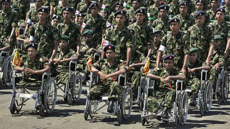 Physically challenged Sri Lankan soldiers participate in a victory day parade in Colombo, Sri Lanka, Friday, June 18, 2010. (AP / Chamila Karunarathne)
