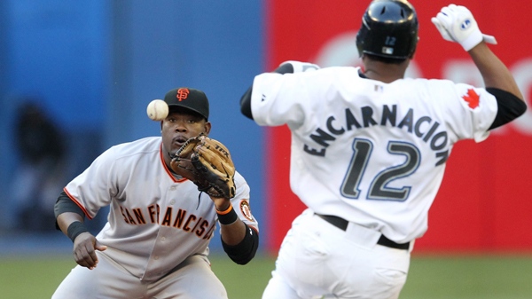 San Francisco Giants shortstop Juan Uribe, left, gets a force out of Toronto Blue Jays' Edwin Encarnacion at second base during third inning interleague MLB baseball action in Toronto Friday, June 18, 2010. (Darren Calabrese / THE CANADIAN PRESS)