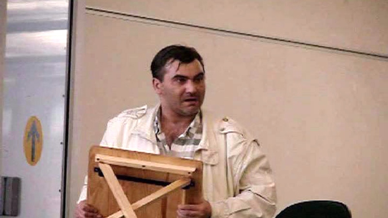 Robert Dziekanski holds a small table before being Tasered at the Vancouver Airport in this image from video.