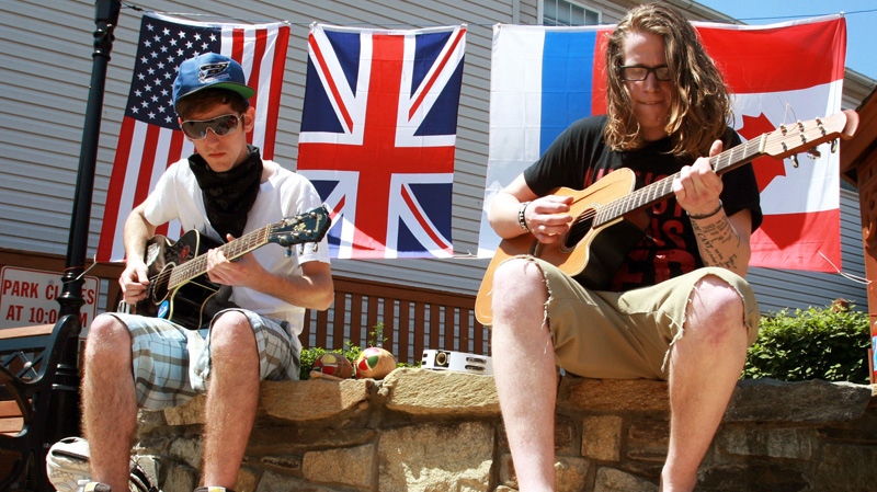 Thurmont, Md. residents Treue Eiler, left, and Kyle Etzler play some John Lennon songs, Friday, May 18, 2012. (AP / Timothy Jacobsen)