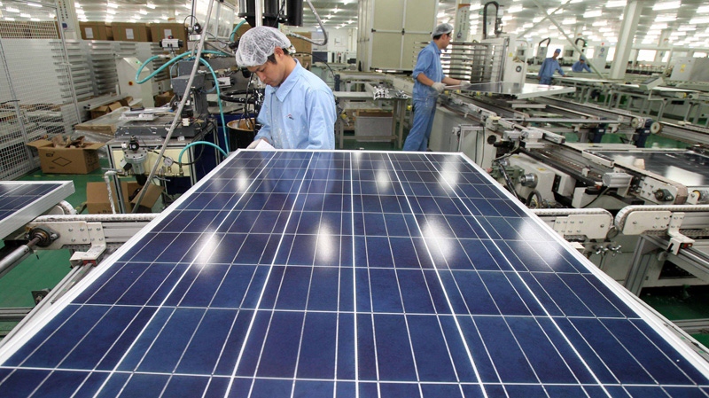 In this photo taken Nov. 18, 2011 and released by China's Xinhua News Agency, Chinese work on the production line at a solar panel factory of the Eoplly New Energy Technology Co., Ltd. in Nantong City, east China's Jiangsu Province. (AP Photo/Xinhua, Xu Congjun)