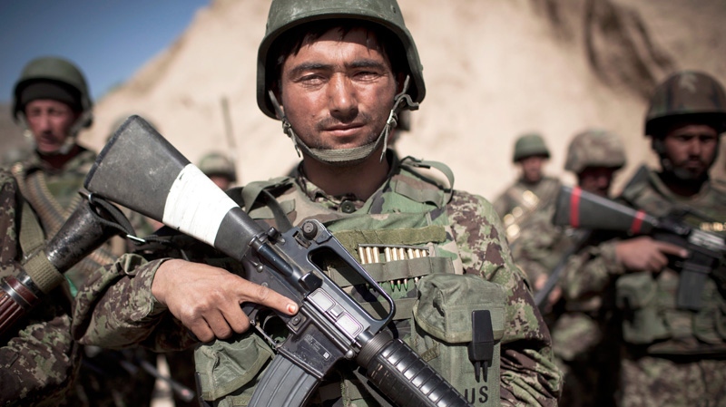 An Afghan National Army soldier lines up with others before joining a patrol in Logar province, east Afghanistan, Thursday, May 17, 2012. (AP / Anja Niedringhaus)