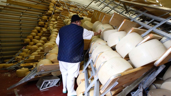 Oriano Caretti looks at the overturned shelves with Parmesan wheels in his Parmesan cheese factory in San Giovanni in Persiceto , Italy, Monday, May 21, 2012. (AP / Luca Bruno)