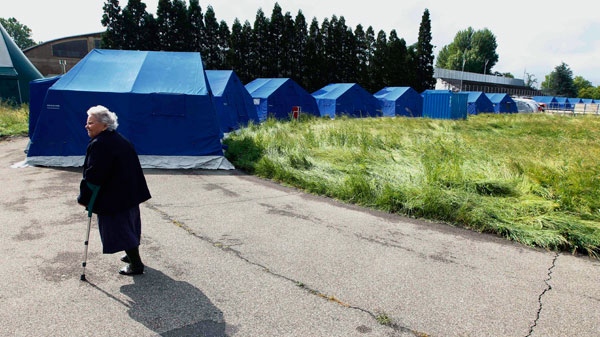 Ettelvige Malaguti, 82, walks through a tent care center in Finale Emilia, Italy, Monday, May 21, 2012. (AP / Luca Bruno)