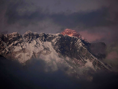 In this Oct. 27, 2011 file photo, the last light of the day sets on Mount Everest as it rises behind Mount Nuptse as seen from Tengboche, in the Himalaya's Khumbu region, Nepal. (AP Photo/Kevin Frayer)