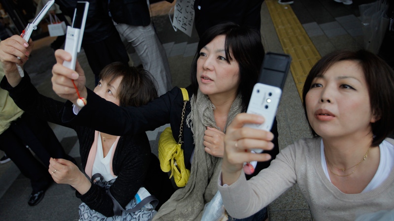 Visitors take photos of the Tokyo Skytree at its grand opening in Tokyo, Tuesday, May 22, 2012. (AP / Itsuo Inouye)