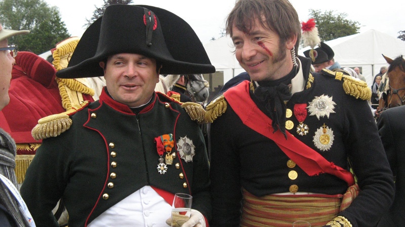 French Emperor Napoleon Bonaparte (left), actually a Waterloo re-enactor, Franky Simon, and one of the emperor's senior officers, Marshal Ney, aka Frank Samson, commiserate with one of their supporters after having lost the Battle of Waterloo yet again, Sunday, June 20, 2010 south of Brussels, Belgium. (Tom Douglas / THE CANADIAN PRESS)