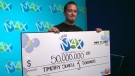 Timothy Schell accepts a cheque for $50 million on May 22, 2012.