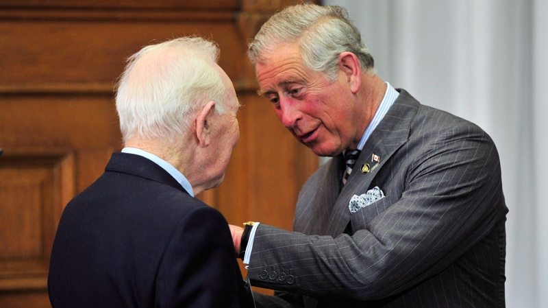 Prince Charles presents a Queen's Diamond Jubilee Medal to Lou Wise in Toronto on Tuesday, May 22, 2012. (Paul Chiasson / THE CANADIAN PRESS)