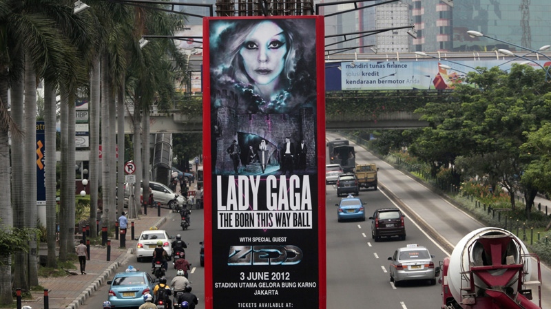 Motorists ride past a promotional banner for US singer Lady Gaga's Born This Way Ball Asia Tour in Jakarta, Indonesia, Tuesday, May 15, 2012. (AP Photo/Dita Alangkara)