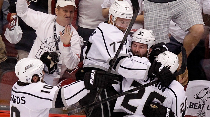 Los Angeles Kings' Dustin Penner celebrates his game-winning goal against the Phoenix Coyotes with teammates in overtime during Game 5 of the NHL Stanley Cup Western Conference finals in Glendale, Ariz., on Tuesday, May 22, 2012. (AP / Ross D. Franklin)