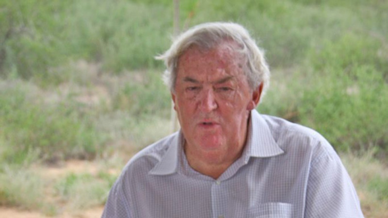 In this 2008 photo provided by the Turkana Basin Institute, paleoanthropologist Richard Leakey discusses the evidence for human evolution over a collection of hominin fossil casts at the Turkana Basin Institute's Ileret research facility in northern Kenya. 