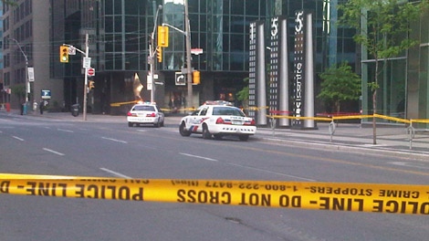 Police close the street and sidewalk after glass fell from a building at 155 Wellington St. on Monday, May 28, 2012.