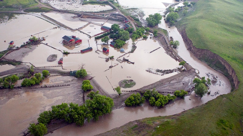 A farm sits flooded along the Trans Canada highway near Irvine, Alta., parts of the highway remain closed and some are underwater east of Medicine Hat, Alta., Monday, June 21, 2010. (Jeff McIntosh / THE CANADIAN PRESS)