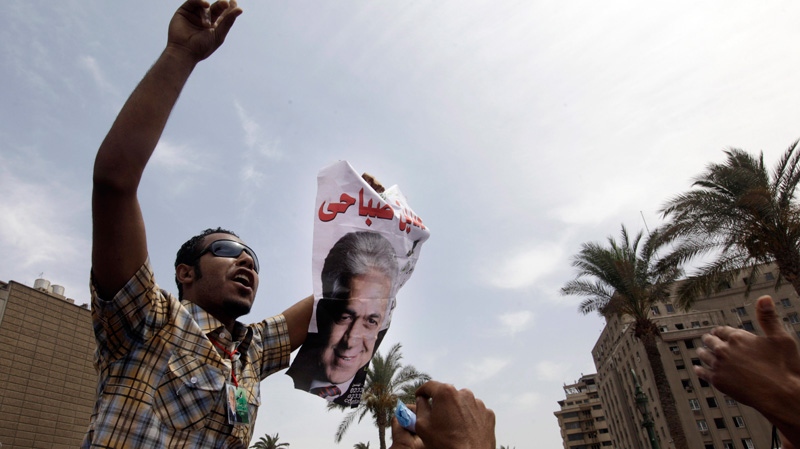 An Egyptian man holds a poster of former presidential candidate Hamdeen Sabahi, during a protest against the results of presidential elections at Tahrir Square, the focal point of Egyptian uprising, in Cairo, Egypt