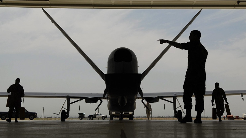 In a Monday, June 30, 2008 photo, Sr. Airman Nicholas Hart helps guides an RQ-4 Global Hawk Block-20 into its hangar at Beale Air Force Base in Yuba County, Calif. 