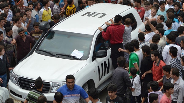 In this citizen journalism image, Syrians gather around a U.N. observers vehicle during a demonstration in Kfarnebel, Idlib province, northern Syria on Tuesday, May 29, 2012. (AP / Edlib News Network) 