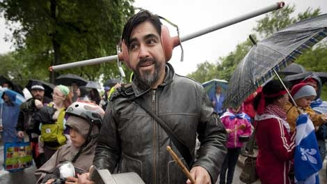 Xavier Ovando wears toilet plungers to protect his ears from the noise of banging pots and pans, during a march through the streets of Montreal in support of the student strike and to protest against bill 78 on Saturday, June 2, 2012. THE CANADIAN PRESS/Peter McCabe
