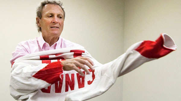 Canadian hockey legend Paul Henderson, 67, who scored the game-winning goal during the 1972 Summit Series against the Soviet Union, tries on his original 1972 Canada jersey in his office in Mississauga, Ont., on Monday, June 7, 2010. (Nathan Denette / THE CANADIAN PRESS)