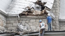 Workers survey the damage as they begin to clean up the damage to a church in Gracefield, Que. following an earthquake Wednesday, June 23, 2010. (Adrian Wyld /  THE CANADIAN PRESS)