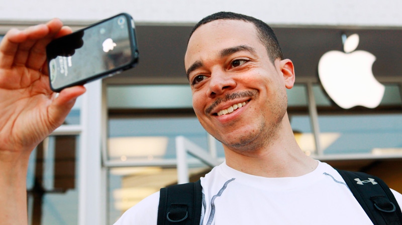 Thomas Smith, 32, of Boston, tries out the video on his new iPhone after standing in line outside the Apple Store in the Georgetown neighborhood of Washington, on Thursday, June 24, 2010. (AP / Jacquelyn Martin)