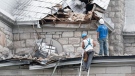 Workers survey the damage as they begin to clean up the damage to a church in Gracefield, Quebec following an earthquake Wednesday June 23, 2010. THE CANADIAN PRESS/Adrian Wyld