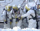 York police drug squad officers wear protective gear as the remove hazardous material from an ecstasy drug lab bust in Markham, Ont., on Tuesday, Dec. 18, 2007.
