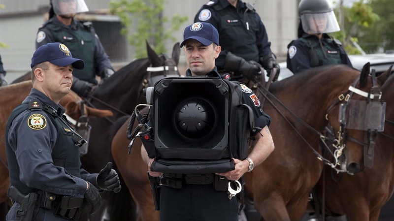 A police officer stands by with and LRAD-X 100 Acoustic Communication Device (sound cannon) during a demonstration of G20 security and crowd control measures in Toronto on Thursday, June 3, 2010. (Frank Gunn / THE CANADIAN PRESS)    