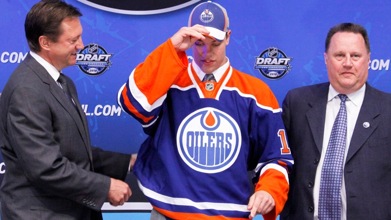 Taylor Hall, center, with NHL commissioner Gary Bettman, left, was the first pick by the Edmonton Oilers in the first round of the 2010 NHL National Hockey League draft. (AP / Reed Saxon)