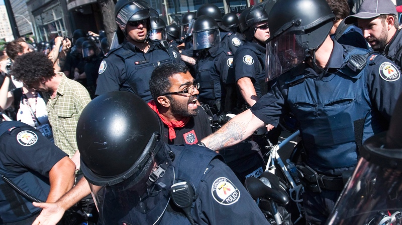 Activists and protesters clash with police while marching along the streets of downtown Toronto during the G8/G20 Summits on Friday, June 25, 2010. (Nathan Denette / THE CANADIAN PRESS)