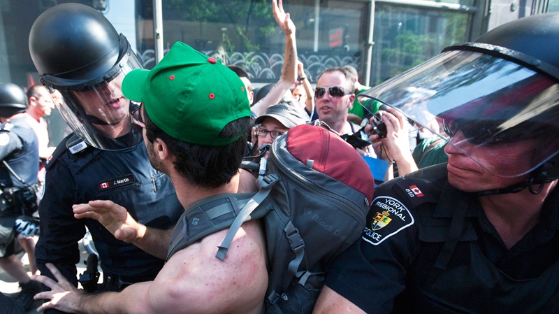 Activists and protesters clash with police while marching along the streets of downtown Toronto during the G8/G20 Summits on Friday, June 25, 2010. (Darren Calabrese / THE CANADIAN PRESS)