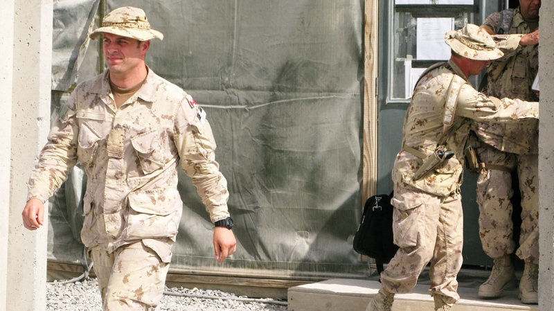 Capt. Robert Semrau (left), and his lawyers leave the military courtroom at Kandahar Airfield in this June 26, 2010 photo. (Bill Graveland / THE CANADIAN PRESS)
