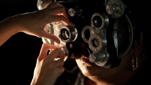 A free eye exam is performed on a patient at the Remote Area Medical clinic inside the Los Angeles Sports Arena on Wednesday, April 28, 2010, in Los Angeles. (AP Photo/Damian Dovarganes)