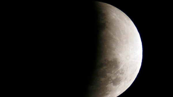The Earth casts a shadow over the moon during a partial lunar eclipse that is observed in Yogyakarta, Central Java, Indonesia, Saturday, June 26, 2010. (AP Photo/Slamet Riyadi)
