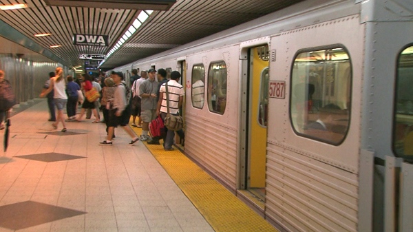 TTC riders get on a subway at Bloor-Yonge Station after it re-opened in Toronto, Sunday, June 27, 2010.