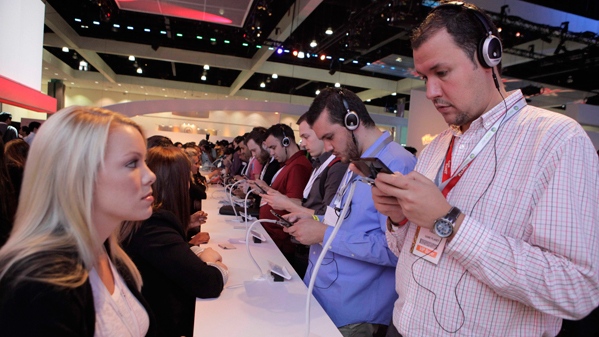Show attendees play video games on Nintendo 3DS at the Nintendo booth at the E3 Expo in Los Angeles, Wednesday, June 16, 2010. (AP / Jae C. Hong)