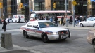 A Toronto police cruiser driving through downtown Toronto.