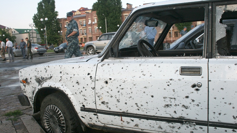 Police officers and investigators looks a car riddled with shrapnel after a bomb blast in Grozny, Chechnya, southern Russia, Wednesday, June 30, 2010. (AP Photo/Musa Police officers and investigators looks a car riddled with shrapnel after a bomb blast in Grozny, Chechnya, southern Russia, Wednesday, June 30, 2010. (AP / Musa Sadulayev)Sadulayev)