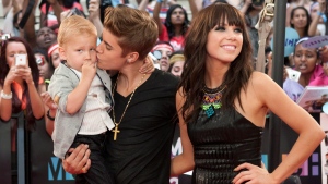 Justin Bieber kisses his brother Jaxon as he poses with Carly Rae Jepsen on the red carpet during the 2012 Much Music Video Awards in Toronto on Sunday, June 17, 2012. Chris Young / THE CANADIAN PRESS