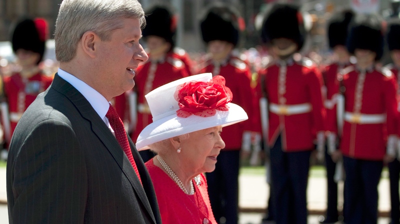Queen Elizabeth walks with Canadian Prime Minister Stephen Harper as she arrives to take part in Canada Day celebrations on Parliament Hill in Ottawa, Thursday July 1, 2010. (Adrian Wyld / THE CANADIAN PRESS)
