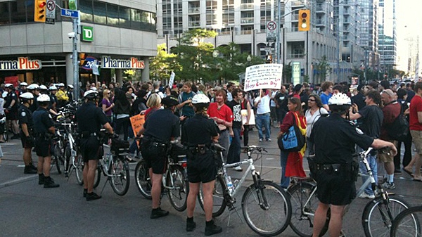 Police keep an eye on a G20 protest march at College St. W. and Bay St. on Thursday, July 1, 2010.