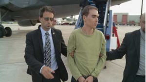 Luka Magnotta exits a plane at Mirabel Airport on June 18, 2012 (SPVM handout)