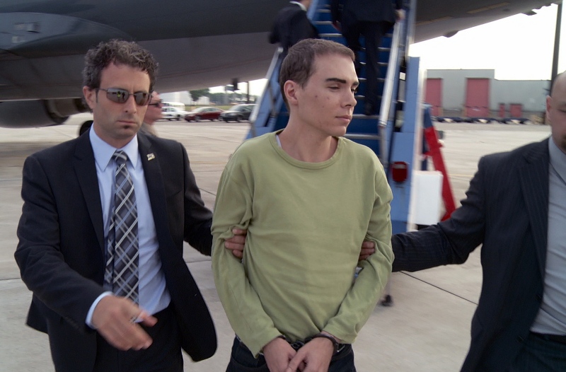 Luka Rocco Magnotta is taken by police from a Canadian military plane to a waiting van in Mirabel, Que., on Monday, June 18, 2012.